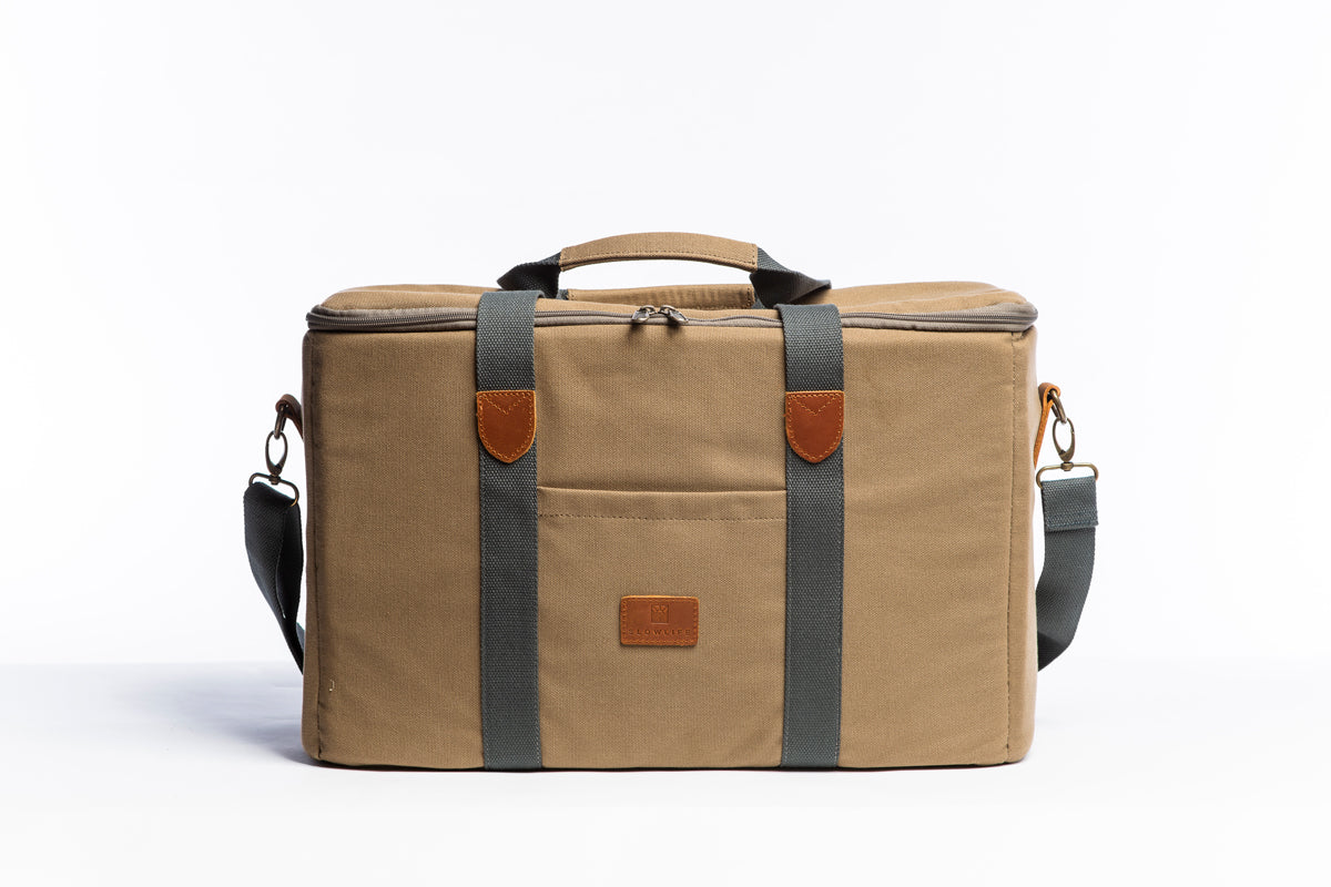 A front on photo of the Olive Slowlife Collection Picnic Bag showing the leather detailing and shoulder strap attached.