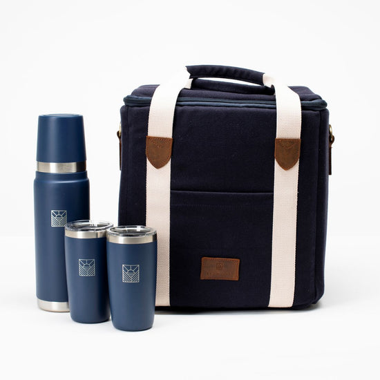 Navy insulated lunch bag with brown accents and three matching blue thermos bottles on a white background
