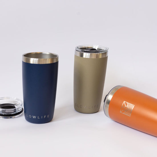 Three insulated tumblers in blue, green, and orange
