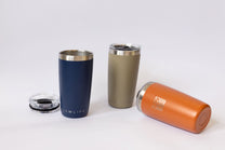 Three insulated tumblers in blue, green, and orange