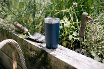 Blue tumbler on a wooden ledge 