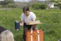 a blue insulated cup and a bag 