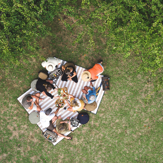 people sitting on the Slowlife Collection Picnic Rugs 