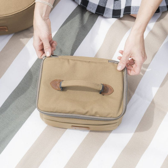 beige suitcase on a striped