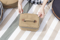 beige suitcase on a striped