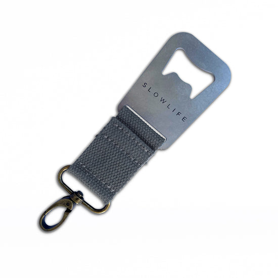Grey Slowlife Collection bottle opener with click attached to one end