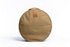 A front on photo of the Olive Slowlife Collection cushion. Showing the leather handle and branded patch.