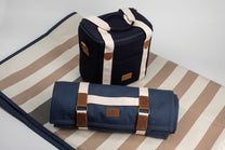 Navy blue bag with brown straps on a striped fabric