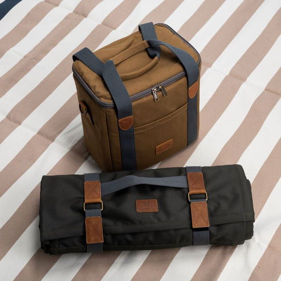 Brown and black bags on a striped fabric