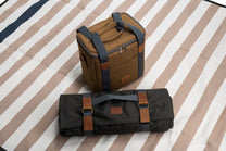 Brown and black bags on a striped fabric