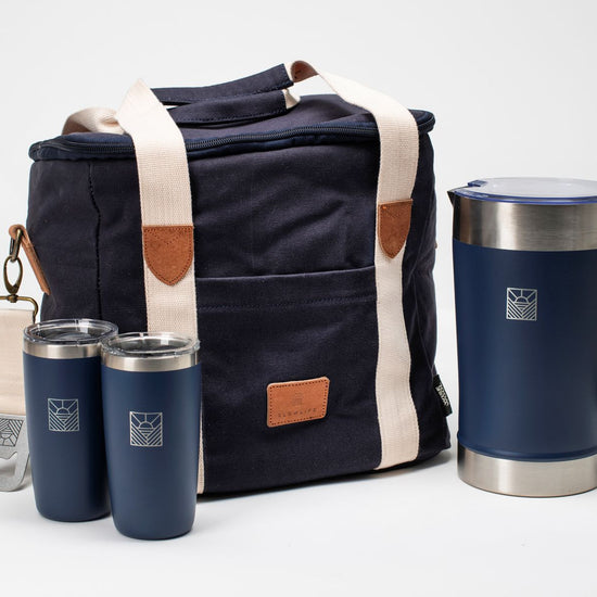 Navy cooler bag with brown accents and matching tumblers