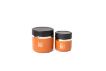 Two orange jars with black lids 