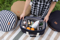 packing a picnic basket with food items