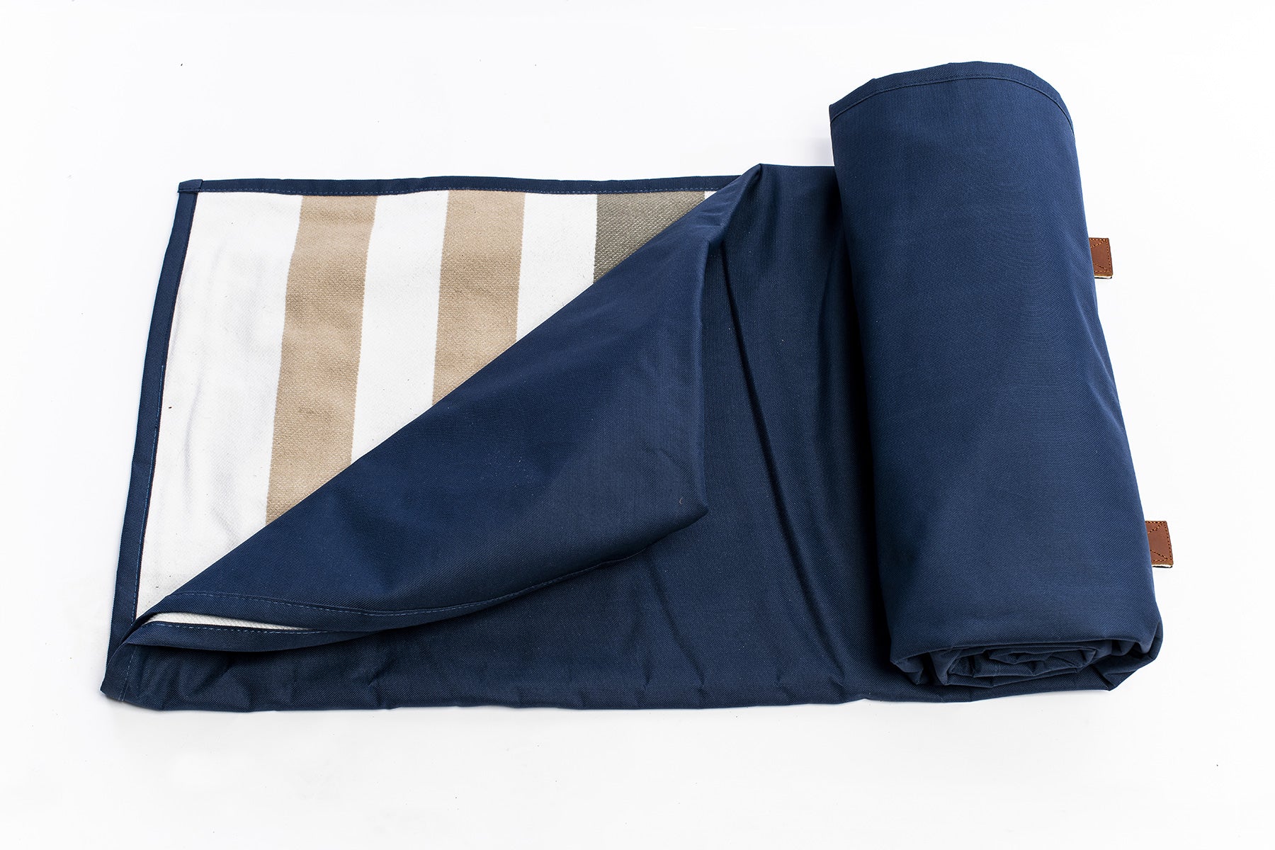 The Navy Slowlife Collection Picnic Rug unrolled slightly to show a bit of the inside patten (cream and olive stripe) of the rug. 