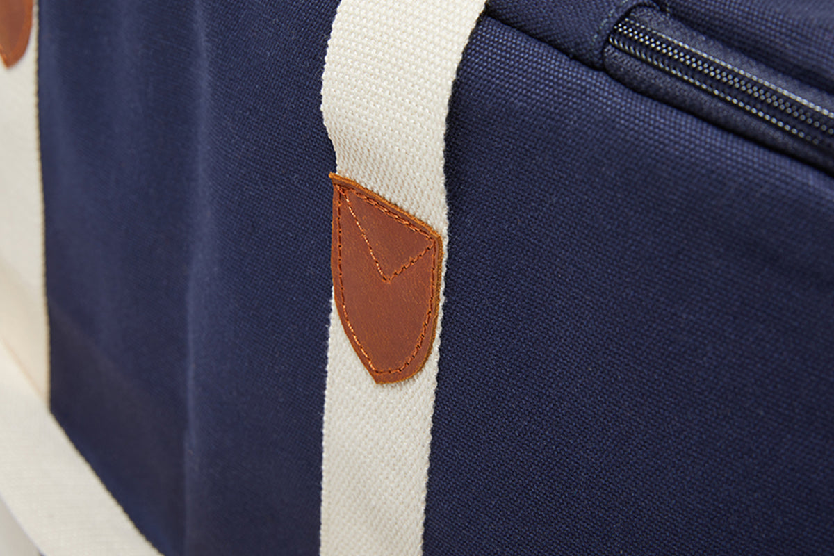 A close up image of the leather strap detailing on the Slowlife Collection Navy Picnic Bag. 